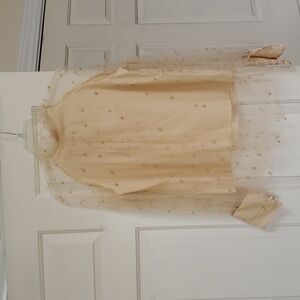 Pearl covered blouse.